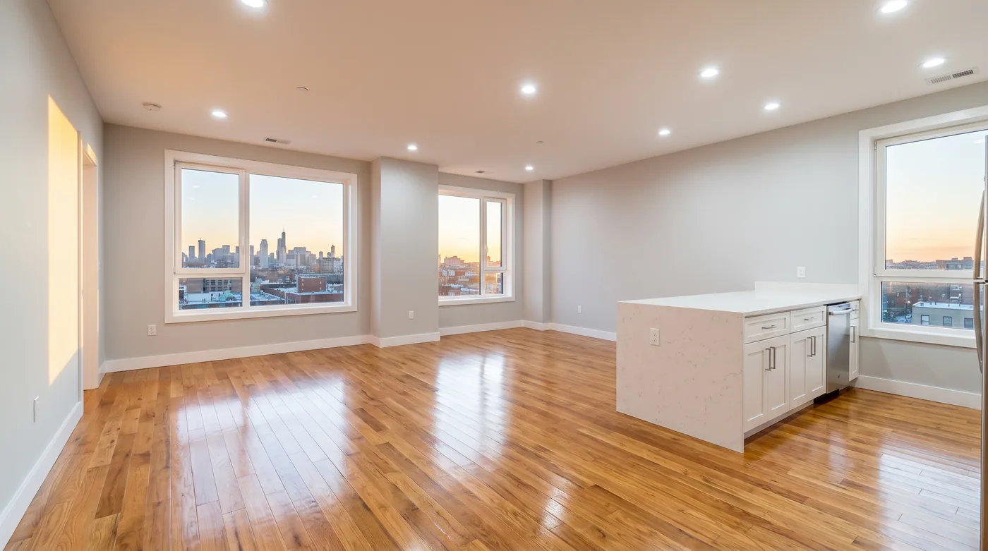 An empty apartment with hardwood floors cleaned to a shine, ready for the next tenant.